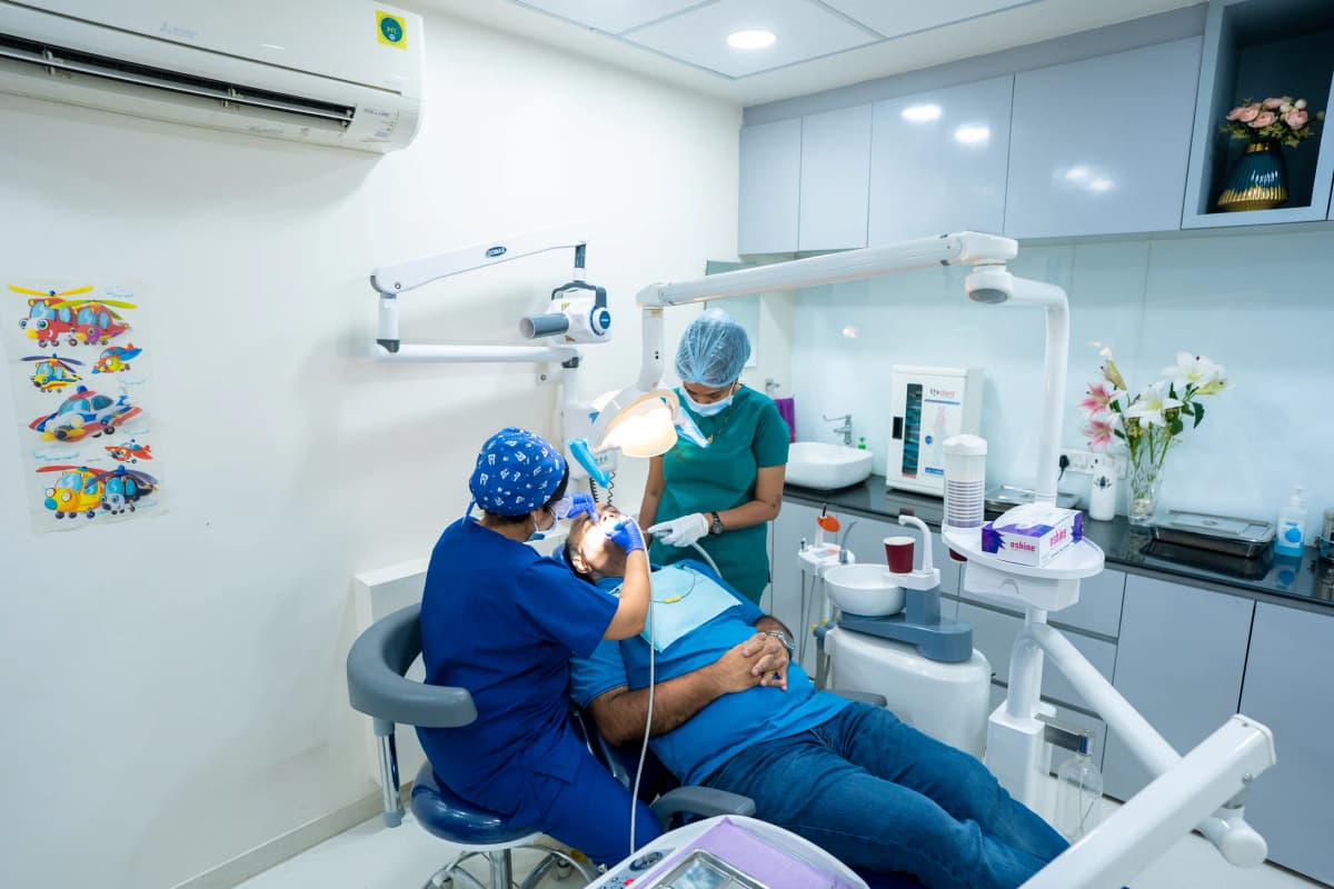 A patient receiving dental treatment at Floss & Gloss Dental Clinic